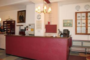 a cash counter in a store with a clock on the wall at Die Fabrik - Hostel in Berlin