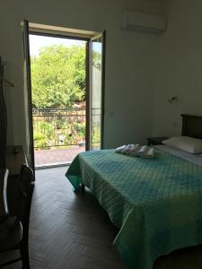 a bedroom with a bed and a sliding glass door at Luna D'Agerola in Agerola