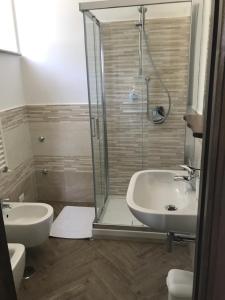 a bathroom with a shower and a sink and a toilet at Luna D'Agerola in Agerola