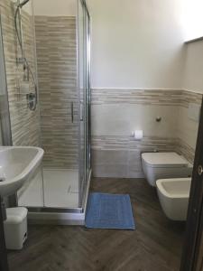 a bathroom with a shower and a sink and a toilet at Luna D'Agerola in Agerola