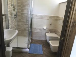 a bathroom with a shower and a toilet and a sink at Luna D'Agerola in Agerola