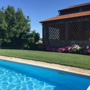 a swimming pool in a yard with a gazebo at B&B Corte Vo Grande in Pegognaga