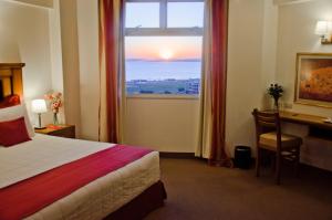 Ένα ή περισσότερα κρεβάτια σε δωμάτιο στο De la Trinidad Hotel