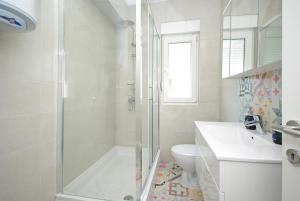 a white bathroom with a shower and a toilet at "NM" Luxury apartments in Split +37 photos