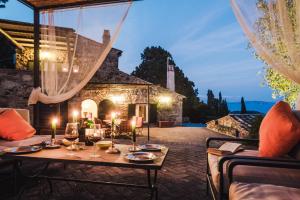 a patio with a table with candles on it at Borgo degli Ulivi in Porto Ercole