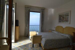 Postel nebo postele na pokoji v ubytování Hotel Villa Sirio