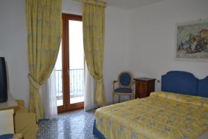 Postel nebo postele na pokoji v ubytování Hotel Villa Sirio