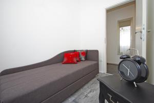 a living room with a couch and a clock on a table at "NM" Luxury apartments in Split