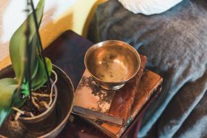 a metal cup on a table next to a plant at Borgo degli Ulivi in Porto Ercole