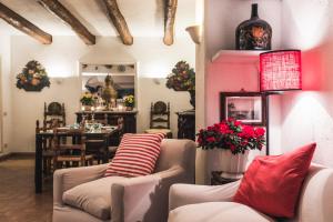 a living room with two couches and a dining room at Borgo degli Ulivi in Porto Ercole