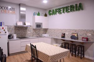 a kitchen with a table and a table and chairs at A Conserveira in Redondela