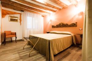 a room with a bed and a chair in it at CA' DE' KOCAI in Venice