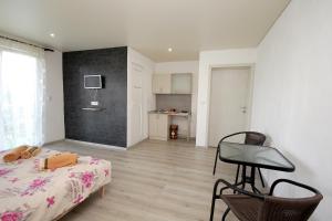 a bedroom with a bed and a chair in a room at Apartments Victoria in Sutomore
