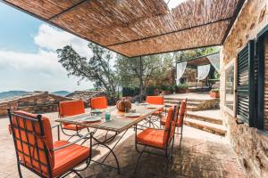 an outdoor patio with a table and chairs at Borgo degli Ulivi in Porto Ercole