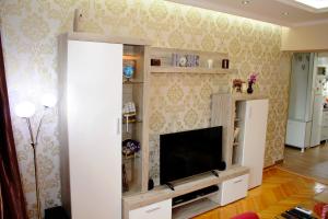 a living room with a flat screen tv in a entertainment center at Kristi Lux Apartment Center Free Parking Fast WiFi in Belgrade