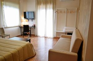 a living room with a couch and a tv at Bed & Breakfast Fontanarossa Airport -Private Parking- in Catania