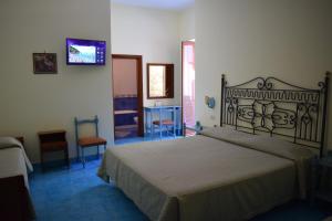 a bedroom with a large bed in a room at Hotel La Certosa in Massa Lubrense