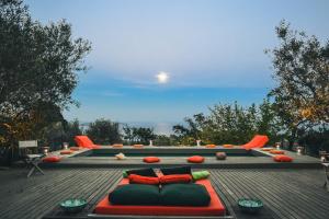a couch on the roof of a house at Borgo degli Ulivi in Porto Ercole