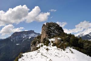 a small building on the side of a snowy mountain at Hotel de Montaña Lamiana in Lamiana