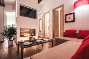 a living room with a couch and a fire place at Borgo degli Ulivi in Porto Ercole