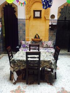 a table and chairs in a room with a table and a couch at Naima's House in Rabat +33 photos