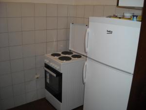 a kitchen with a white stove and a refrigerator at Apartment Sretno Good Luck in Herceg-Novi