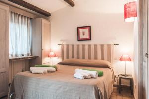 a bedroom with a bed with two pillows on it at Borgo degli Ulivi in Porto Ercole
