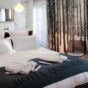 Letto o letti in una camera di Hôtel Quatorze
