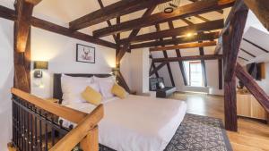a bedroom with a large bed with wooden beams at Antler Boutique in Braşov