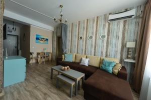a living room with a couch and a table at Velier Apartment in Mamaia