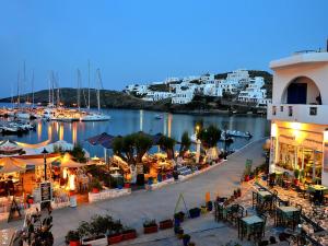a view of a harbor with a marina at night at anerousa in Loutra