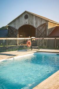 a swimming pool in front of a barn at Beatnik Hotel in Bromont