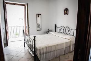 a bedroom with a bed and a large window at Malvasia B&B in Lipari