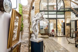 a statue of a man on a pedestal in a lobby at Porta di Castro Boutique Hotel & SPA in Palermo