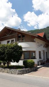 a building with a tree in front of it at Apart Martina in Ried im Oberinntal