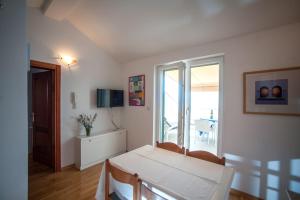 a living room with a white table and a window at House Koloc in Bol