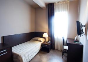 Postel nebo postele na pokoji v ubytování Hotel Le Badie