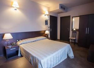 Postel nebo postele na pokoji v ubytování Hotel Le Badie