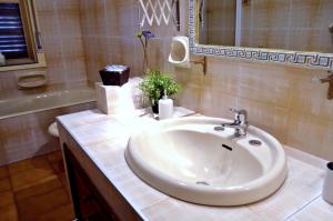 a bathroom with a white sink and a mirror at Bed & Breakfast Fontanarossa Airport -Private Parking- in Catania +34 photos