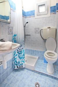 a bathroom with a toilet and a sink and a shower at Mariren in Neo Klima +82 photos