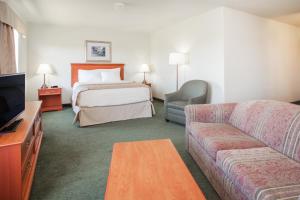 A bed or beds in a room at Super 8 by Wyndham Swan River MB