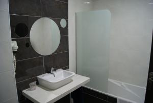 a bathroom with a sink and a mirror at Hotel Doña Luisa in San Luis de Sabinillas