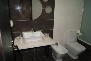 a bathroom with a sink and a toilet at Hotel Doña Luisa in San Luis de Sabinillas