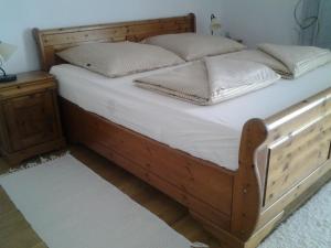 a wooden bed with white sheets and pillows on it at Casa Bellavista in Rijeka +34 photos