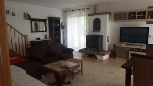 a living room with a couch and a television at Casa Bellavista in Rijeka