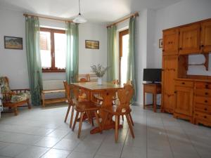 a dining room with a wooden table and chairs at Al Fiume in Arco