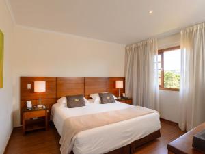 เตียงในห้องที่ Hotel Le Renard - Campos do Jordao