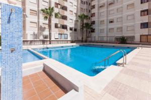 a swimming pool in the middle of a building at Navegante in Gandía