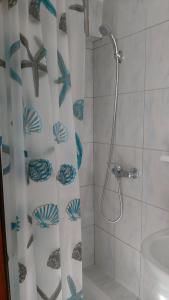 a bathroom with a shower with a shower curtain at Ruza Apartmani in Draga Bašćanska