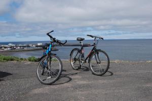two bikes parked next to each other near the water at Bikers Paradise in Ólafsvík